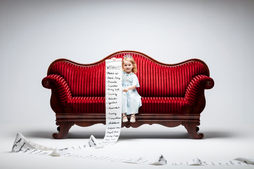 Girl writing massive article on red sofa