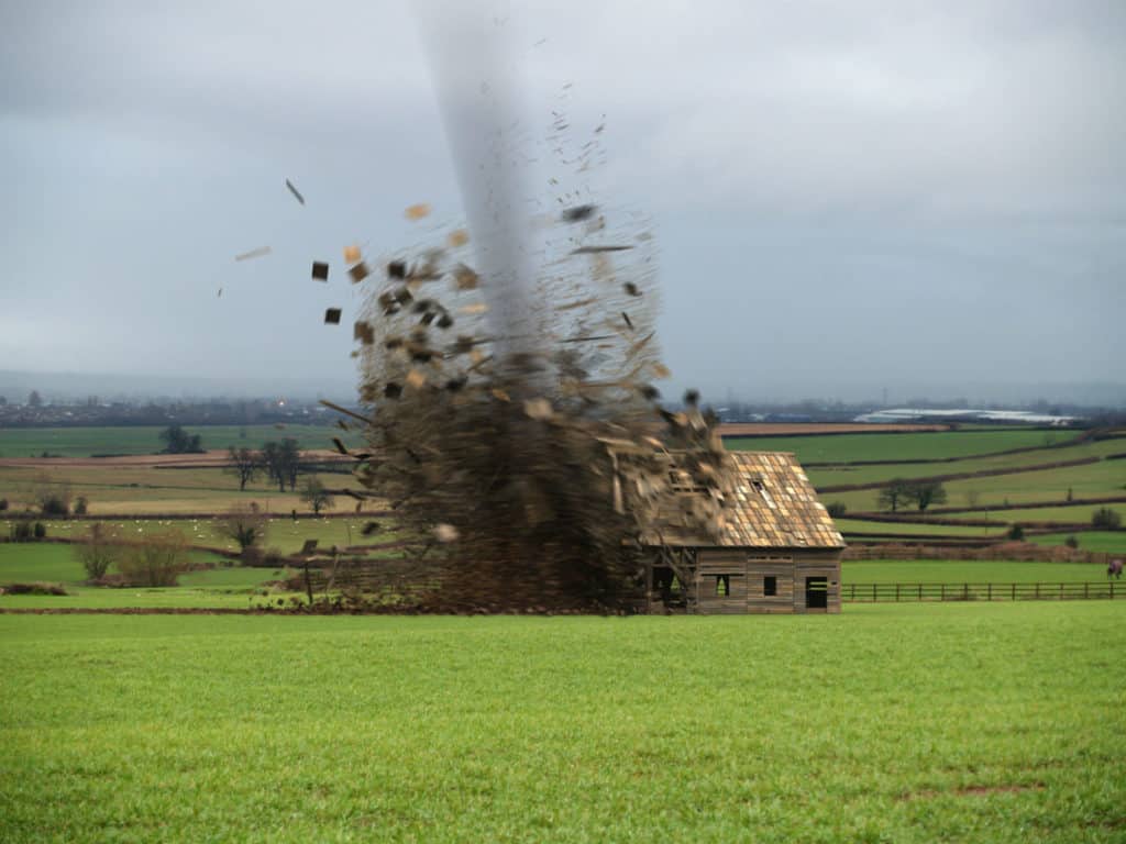 Tornado destroying a barn