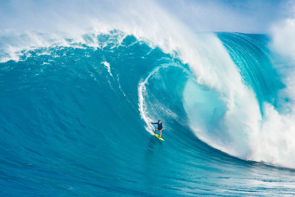 Professional surfer Carlos Burle rides a giant wave at the legendary big wave surf break 