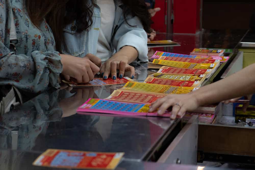 People buying lotto tickets in store