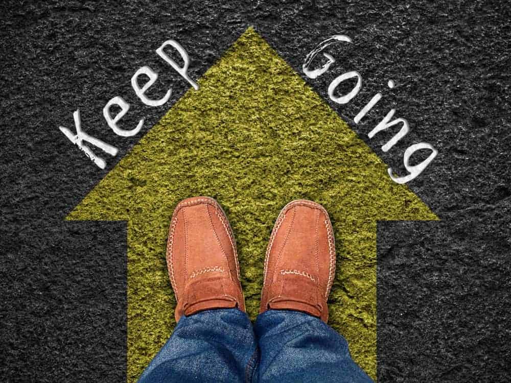 Feet on the yellow arrow with words "keep going".