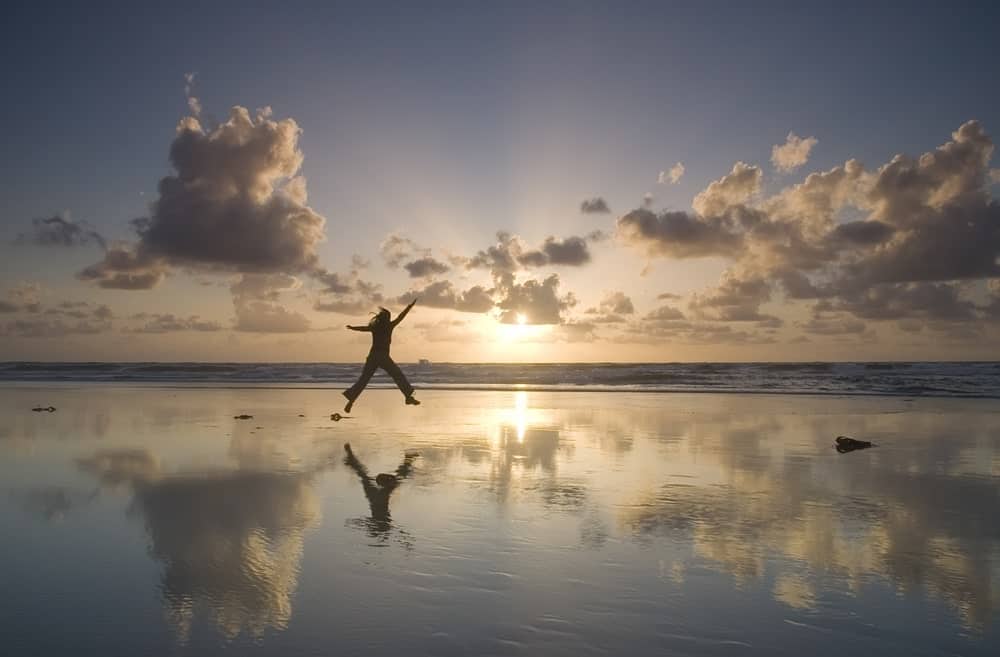 Person taking a leap on the ocean.