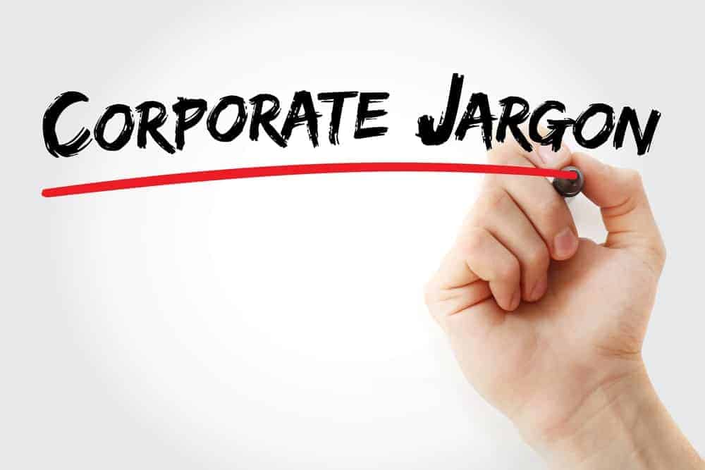 A hand highlighting the word "Corporate Jargon" with a red marker.